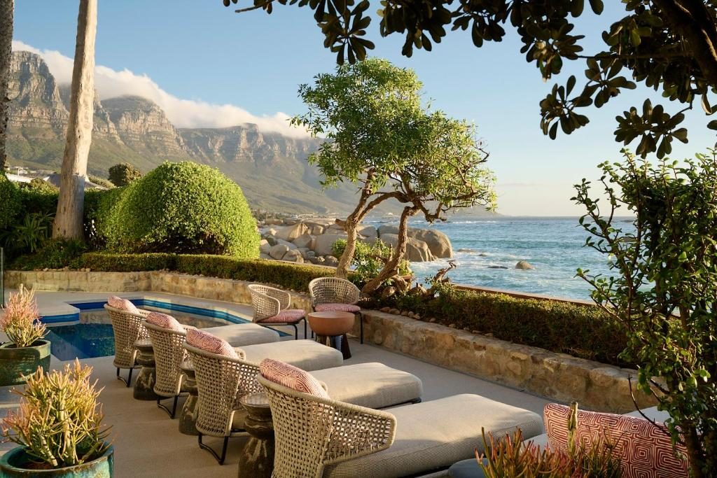A terrace with loungers above the Atlantic, the Twelve Apostles behind